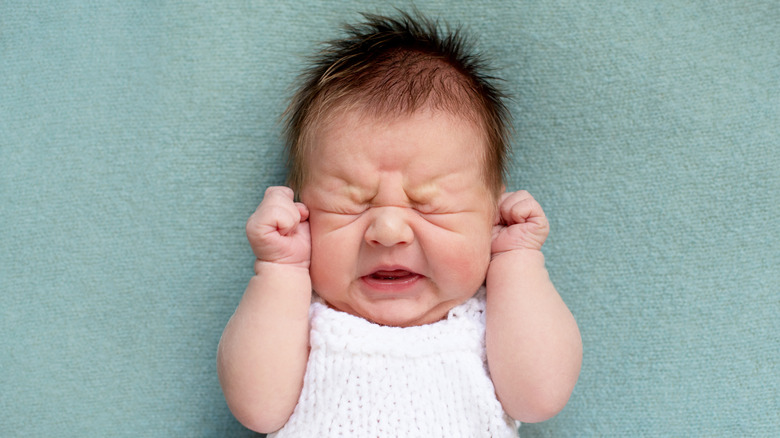 a baby straining to poop 