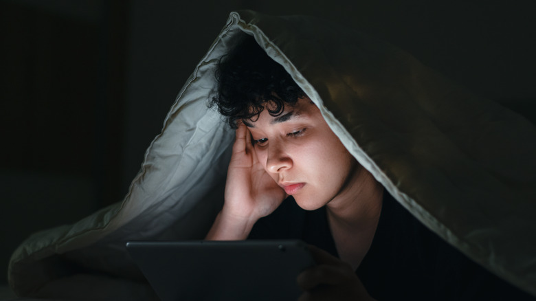 Teenager up late using iPad