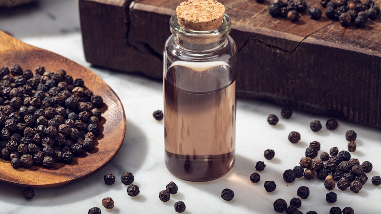 Essential oil bottle with peppercorns