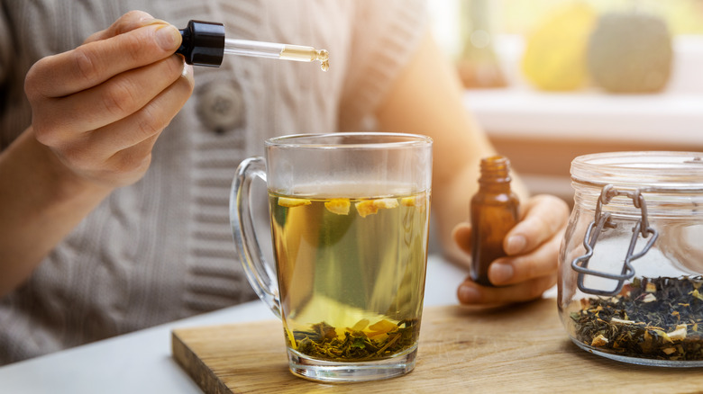 Someone puts CBD oil in their tea