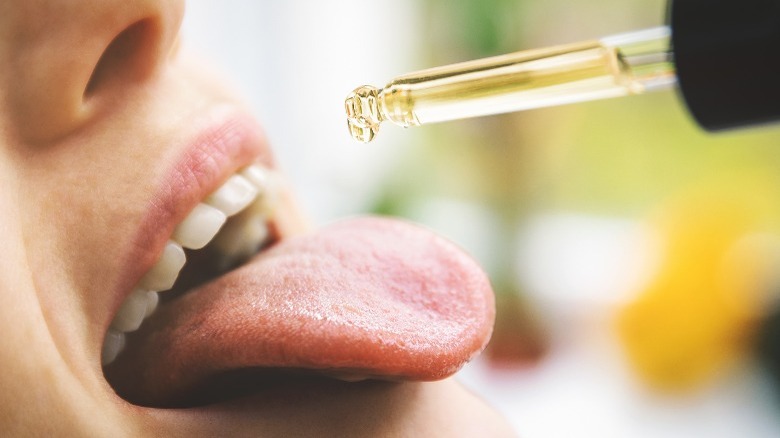 Woman taking CBD oil