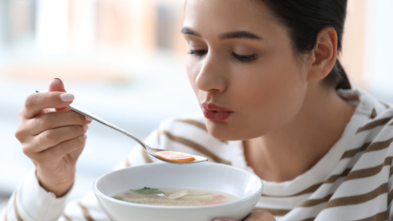 Woman eating soup