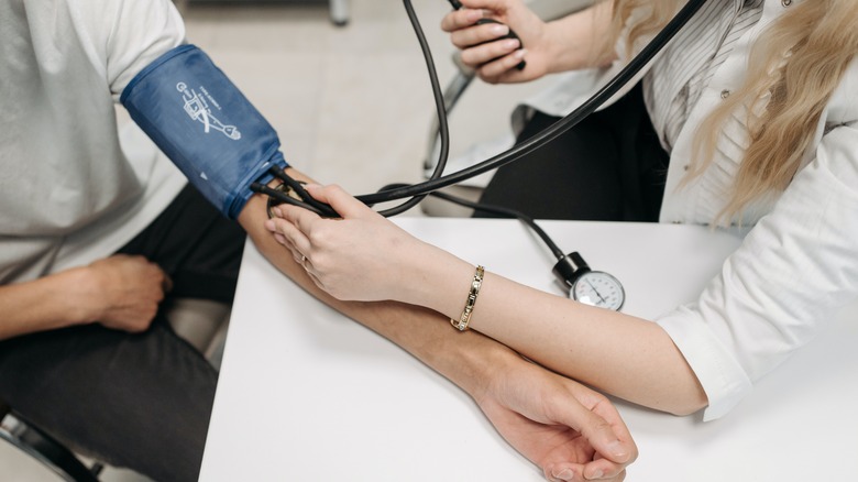 A person having their blood pressure taken