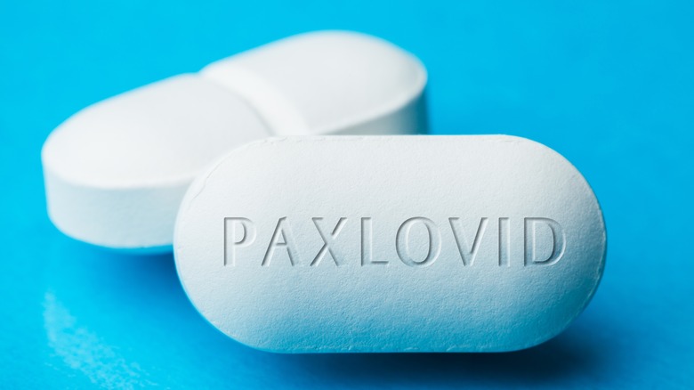 doctor holding box of paxlovid