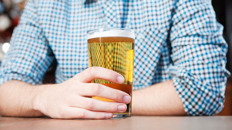 man drinking beer at pub