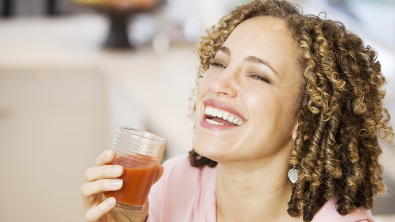 woman drinking glass of V8
