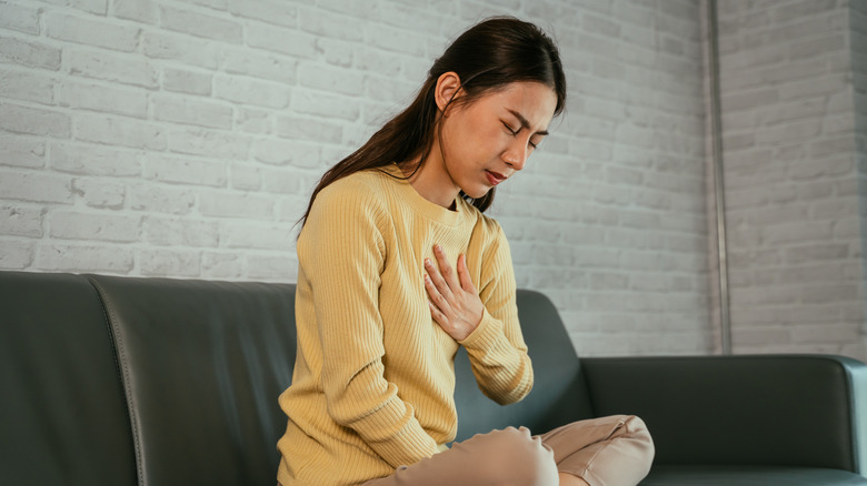 A woman experiences heartburn