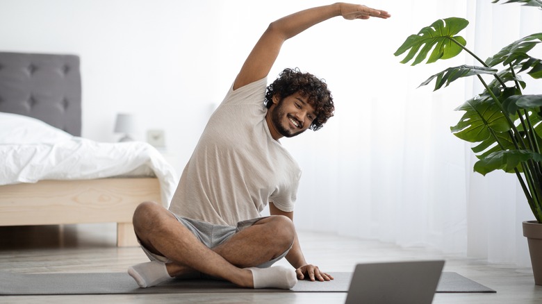 Smiling man in yoga pose