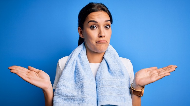 woman with confused expression, hands open