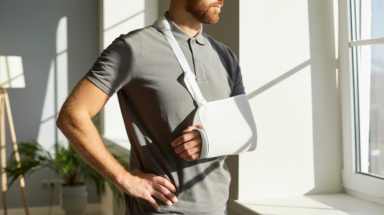 man with arm cast looking out