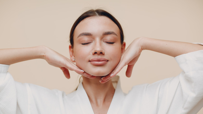 woman with hands under chin in yoga pose