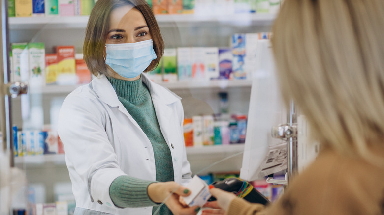 pharmacist giving prescription
