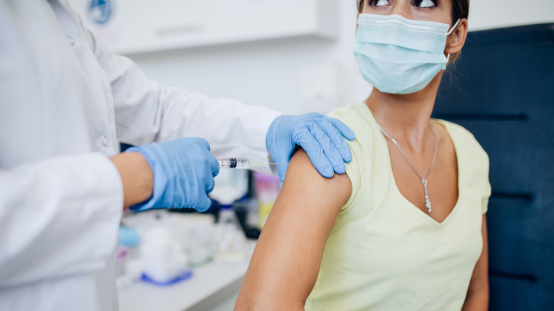 A woman gets a vaccine