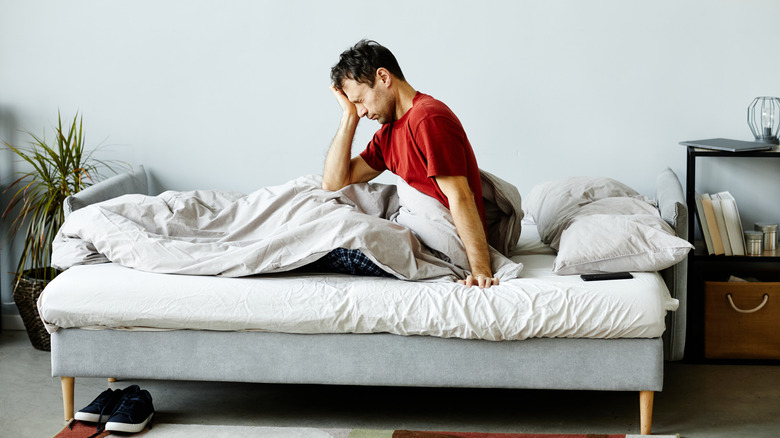 tired man sitting in bed