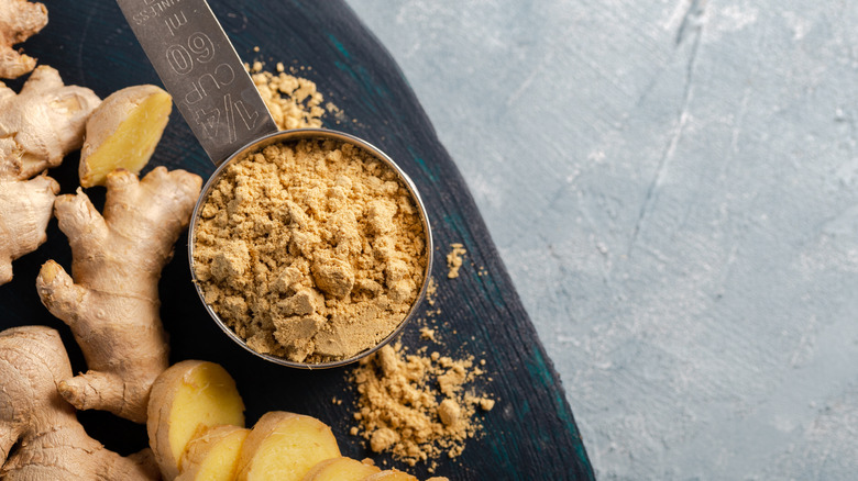 Fresh ginger and ginger powder on a table