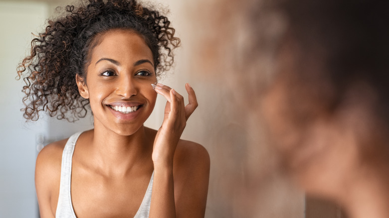 woman applying skin cream