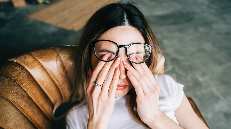 Woman rubbing her eyes