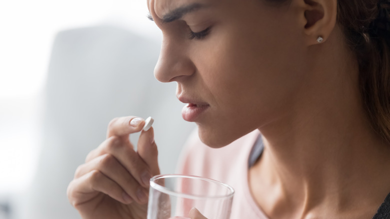 woman taking ibuprofen