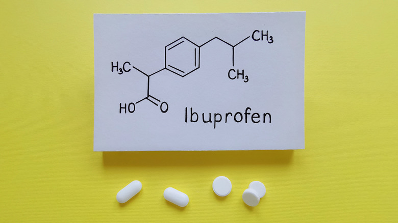 Ibuprofen pills under a paper labelled "ibuprofen"