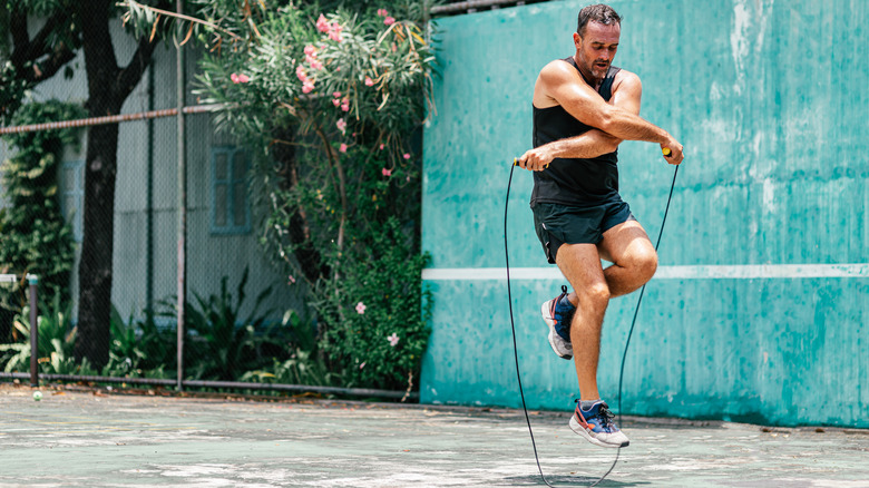 A man jumps rope outside