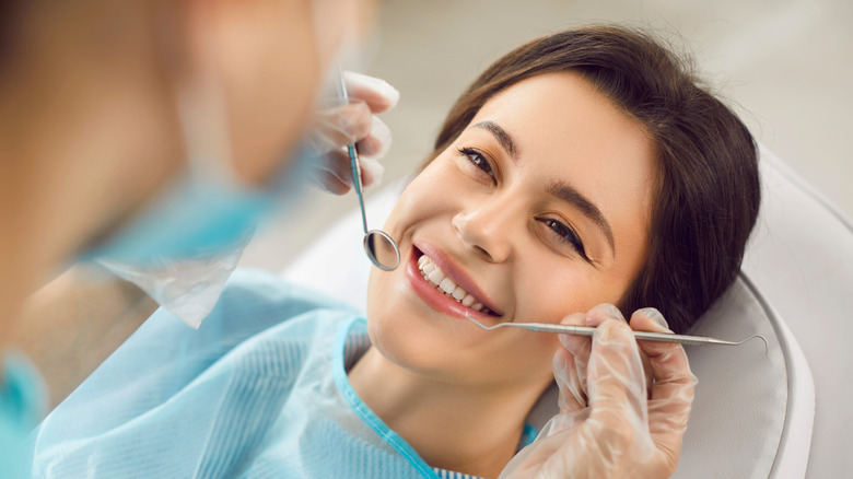 dentist examining woman's teeth
