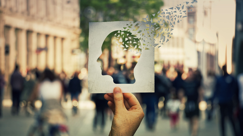a paper of a human head blowing away in the wind 