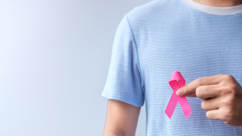 man holding breast cancer ribbon