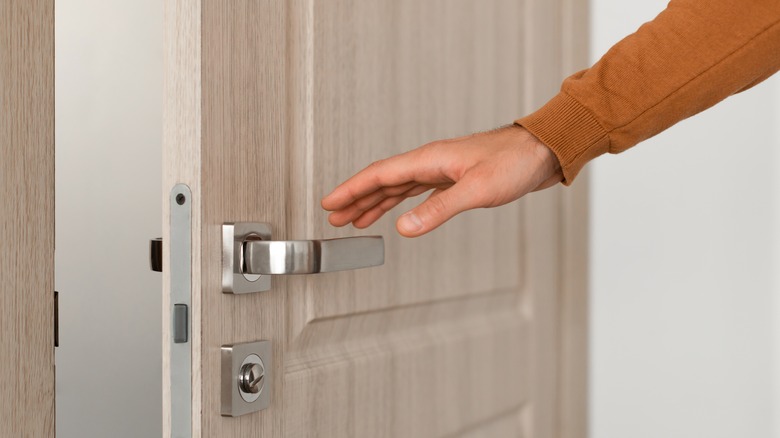 hand reaching for door knob