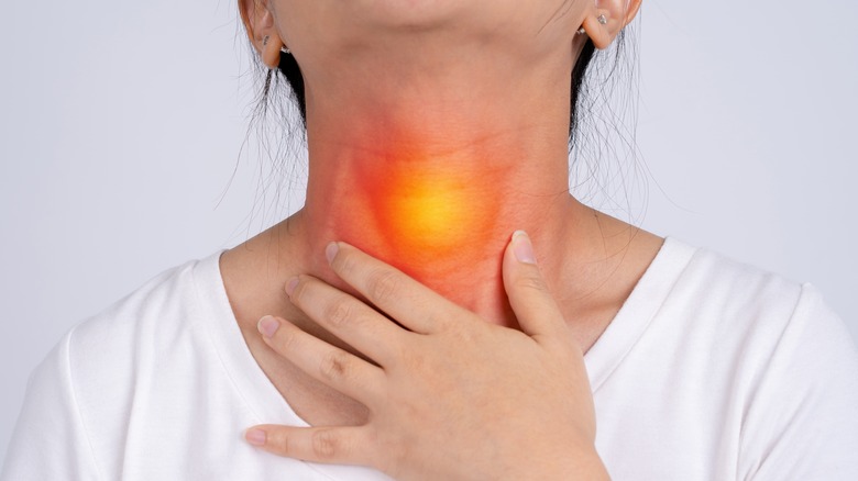 woman with throat pain