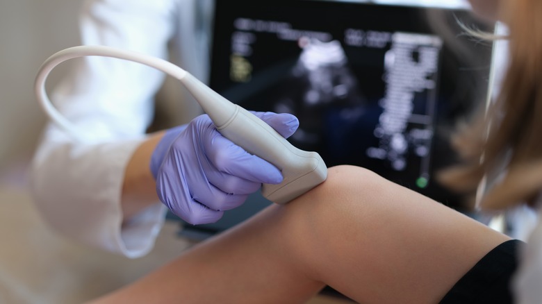 doctor checking patient's joints