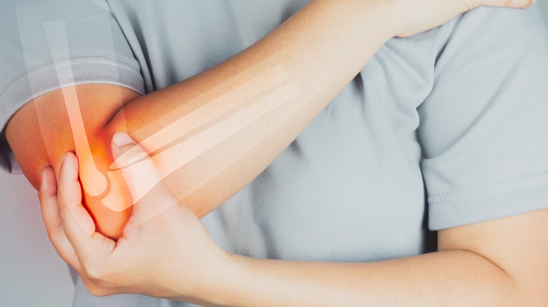 woman holding her elbows
