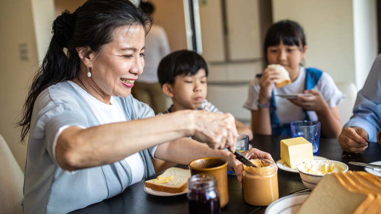 family eating peanut butter on bread