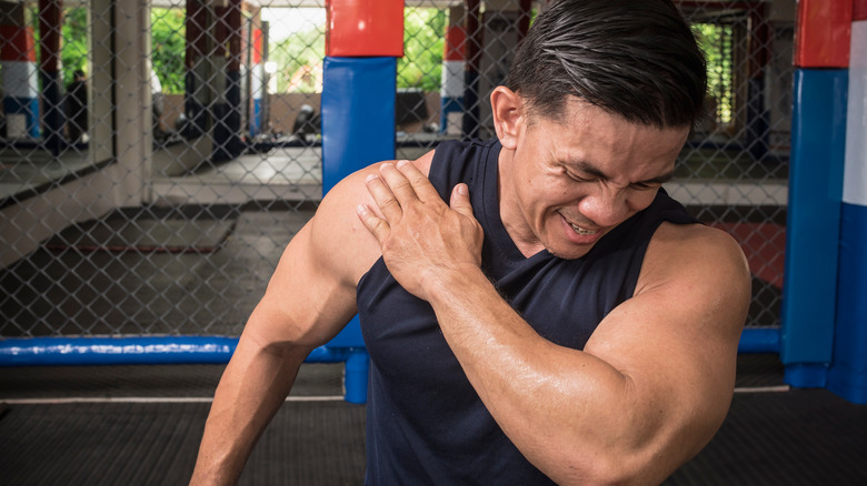 Athlete holding shoulder in pain