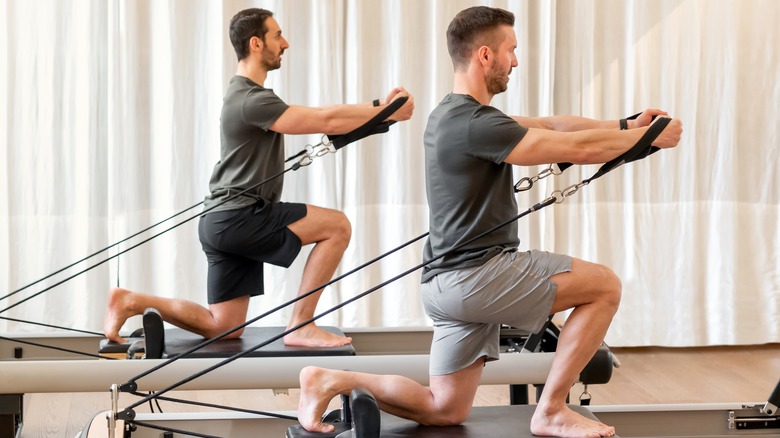 Two men doing reformer Pilates