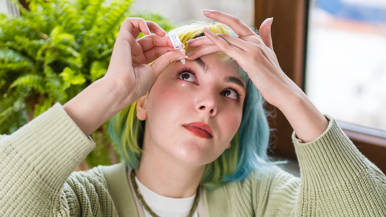 Woman using eye drops