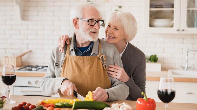 older couple cooking vegetarian dinner 