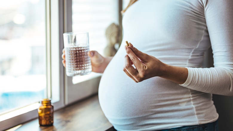 pregnant woman taking vitamins