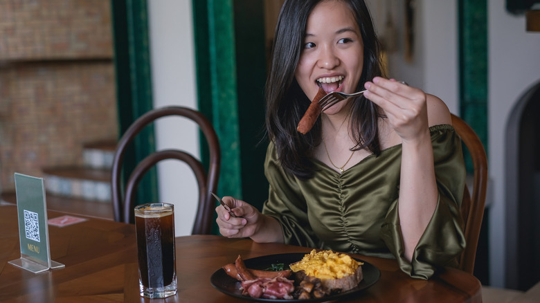 woman eating bacon