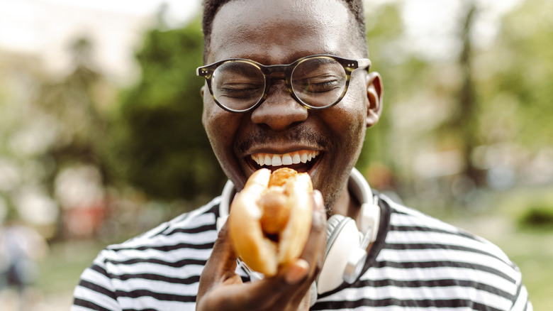 man eating a hot dog