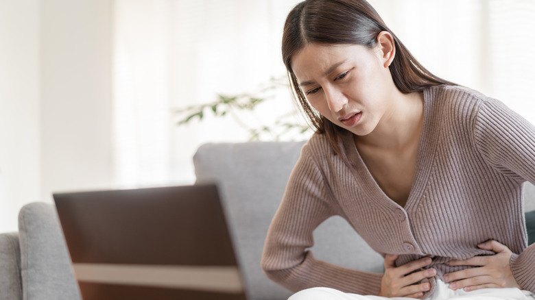 Woman holding her stomach in pain