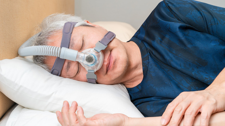 Man sleeping with CPAP machine
