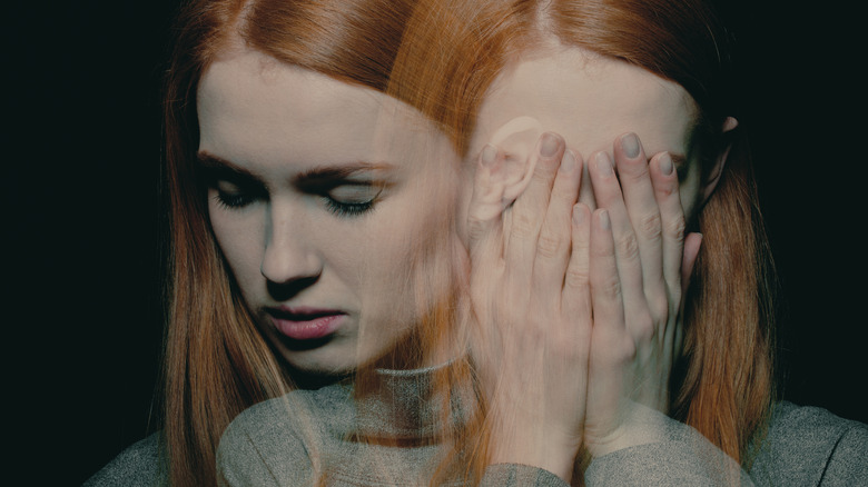 Distressed woman with face in hands