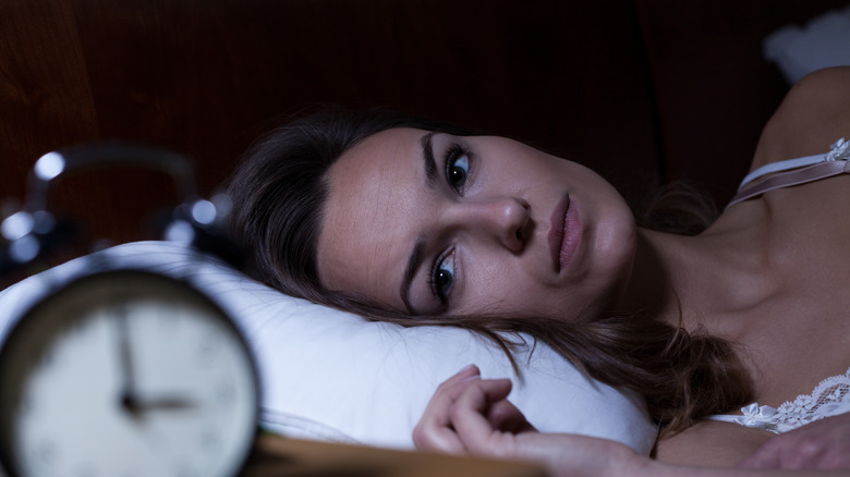 woman lying awake worried