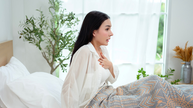 frightened woman in bed after sleep paralysis