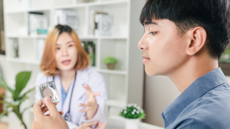 Young man talking to his doctor 