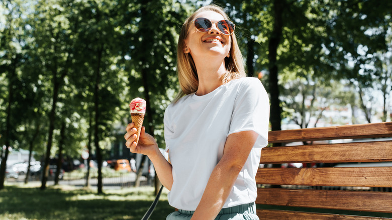 Happy woman eating ice cream