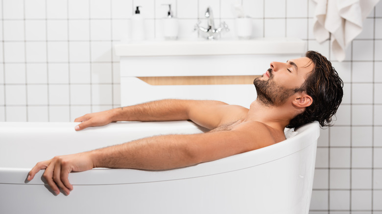 Man relaxing in bathtub