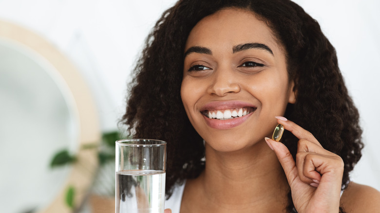 woman taking a fish oil supplement