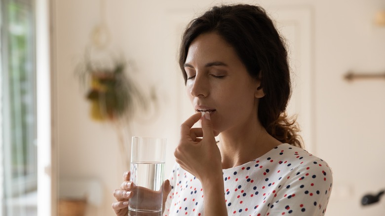 woman taking medications