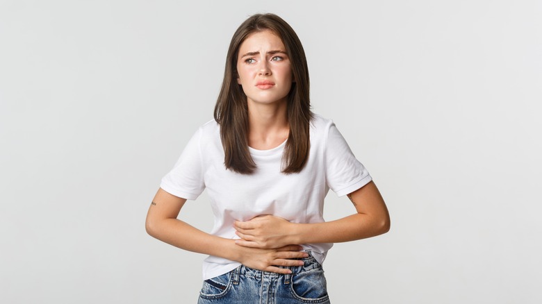 Woman holding her stomach in pain